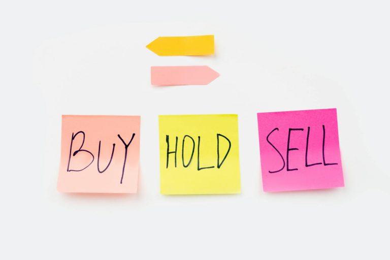 Person counting money while looking exhausted in dim light.